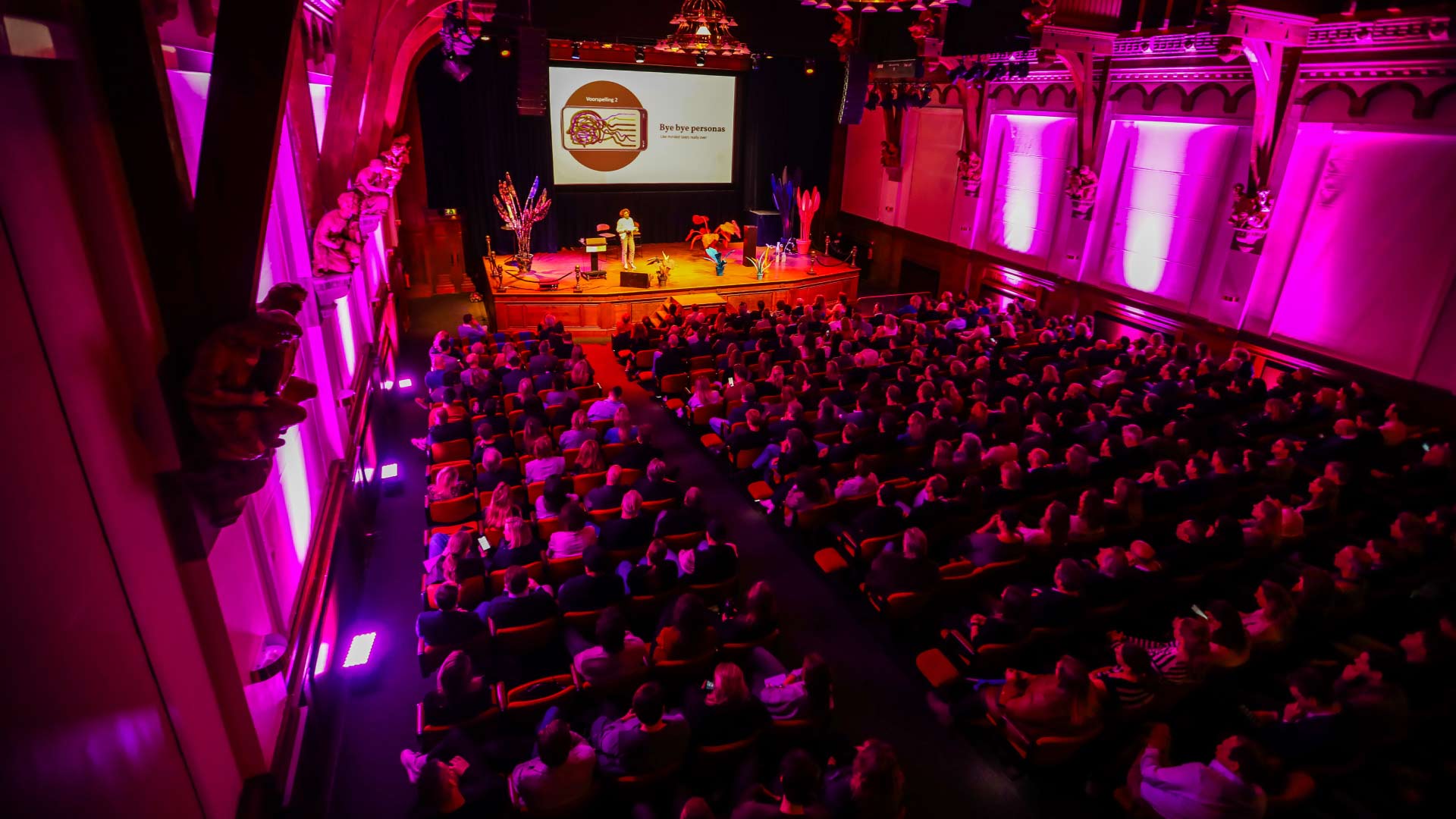 Theatre of KIT Royal Tropical Institute filled with people listening to Mieke De Ketelaere on stage.