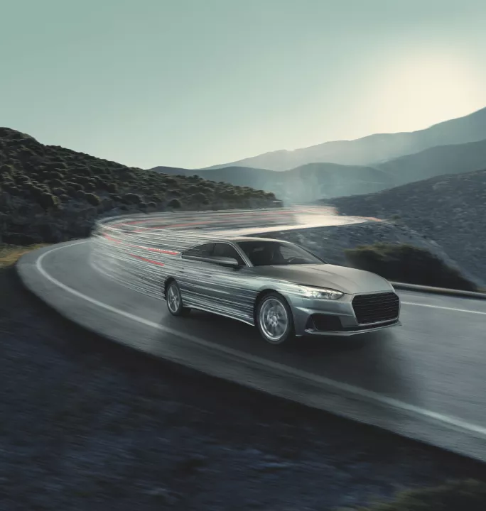 Bridgestone key visual with a sleek silver car speeds around a curvy mountain road, leaving light trails amid a serene mountainous backdrop