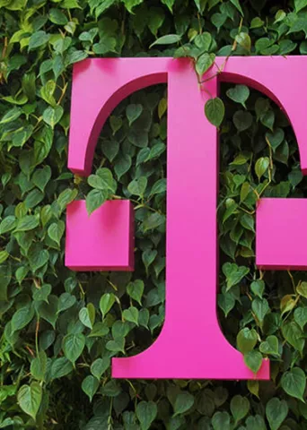 Pink T-Mobile logo on a plant wall.