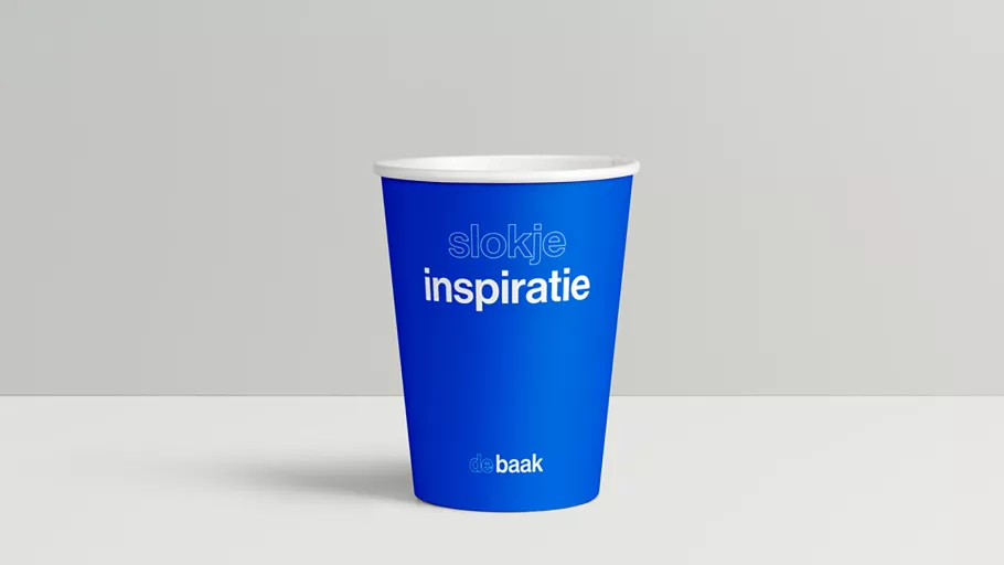 Paper cup in De Baak's new, clean branding.