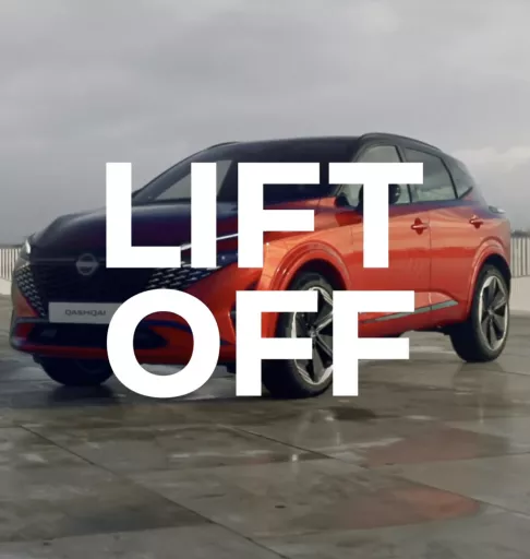 Nissan Qashqai SUV in two-tone black and orange design with large white "LIFT OFF" text overlay, positioned on a paved surface for a promotional social media campaign.