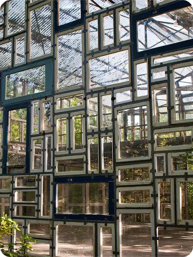 Springbok's Time To Make Sense 2025 Summit at the Verbeken Foundation contemporary art museum. Close-up of an outdoor space or greenhouse made entirely out of vintage wooden windows.